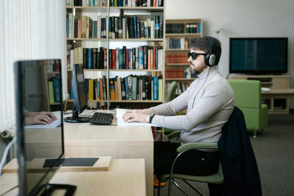 A man sitting at a desk with headphones on