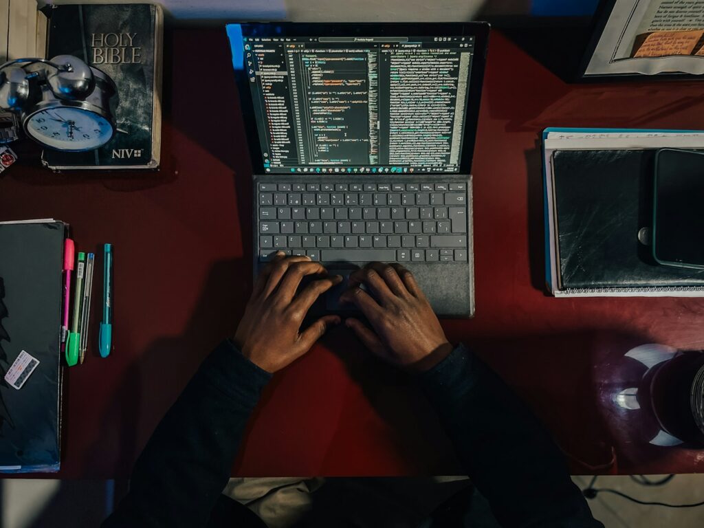 A person sitting at a desk with a laptop