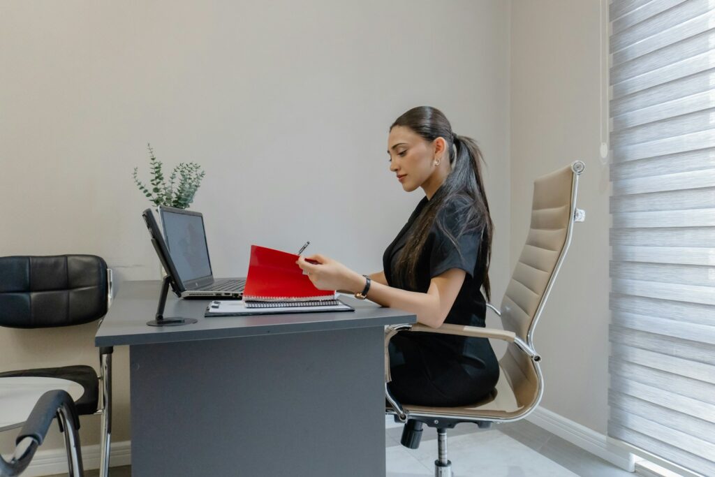 Woman working at a desk with a laptop and laptop.